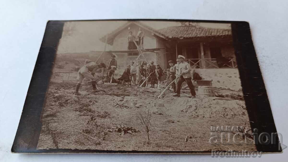 Photo of Boys and Girls Working in the Yard of a Village House