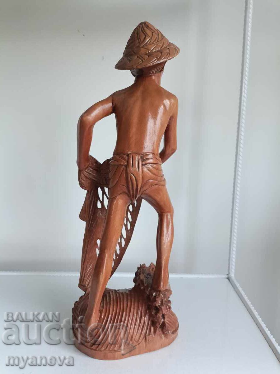 Wood carving of a fisherman from Indonesia with price 120.00 BGN | € 61.36