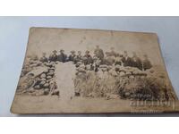 Photo of Men and Boys by a Large Pile of Watermelons