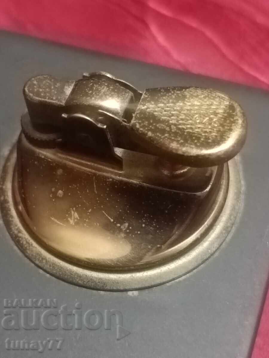 Delivery of Retro bronze lighter from two parts with a massive stone base