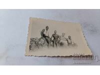 C-bottle Mineral Water Four Soldiers with Shorts on a Rock