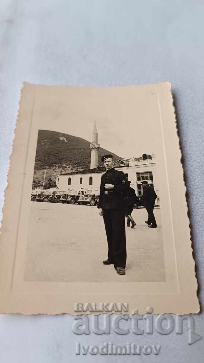 Photo of a Young Person on a Square with Retro Cars Photo of a Young Person on a Square with Retro Cars
