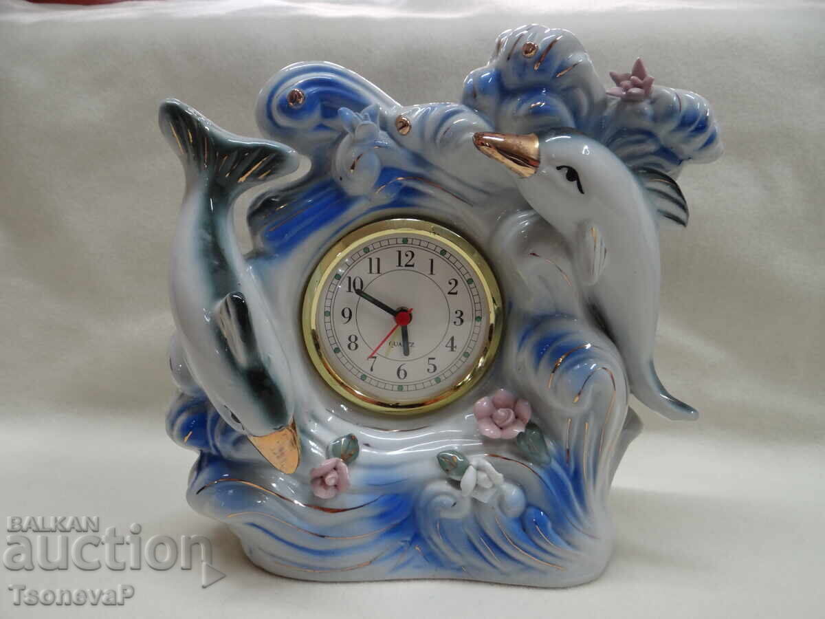 Porcelain clock with dolphins and flowers, working Porcelain clock with dolphins and flowers, working