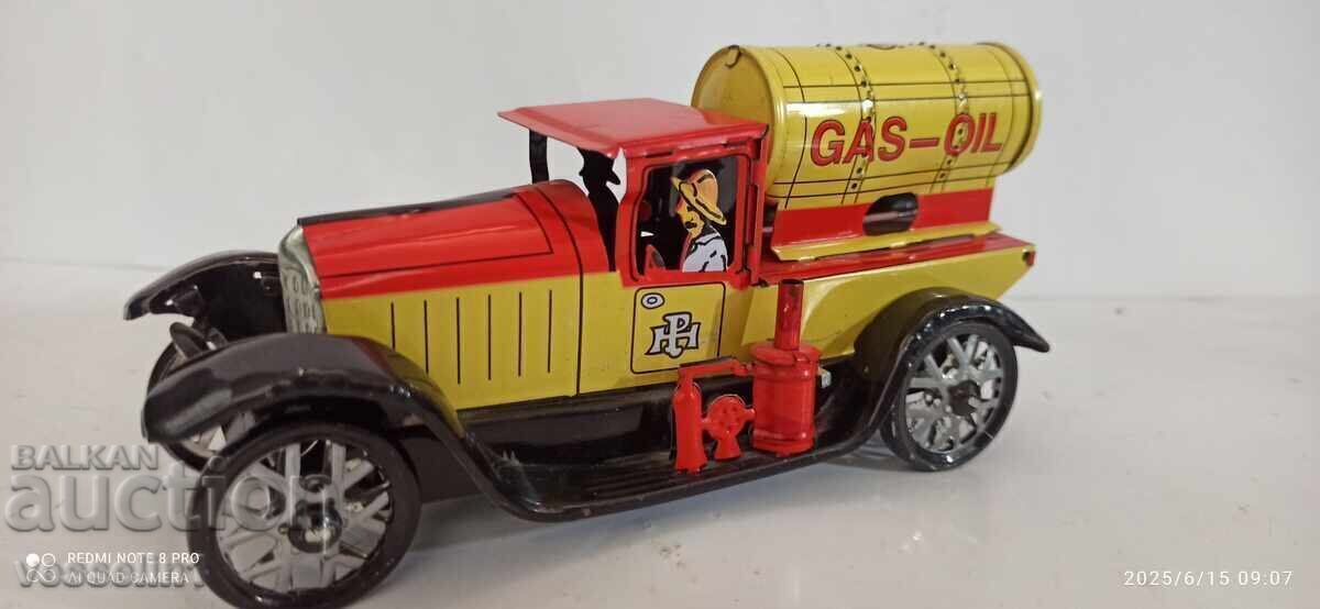 Old sheet metal truck with a wind-up friction mechanism