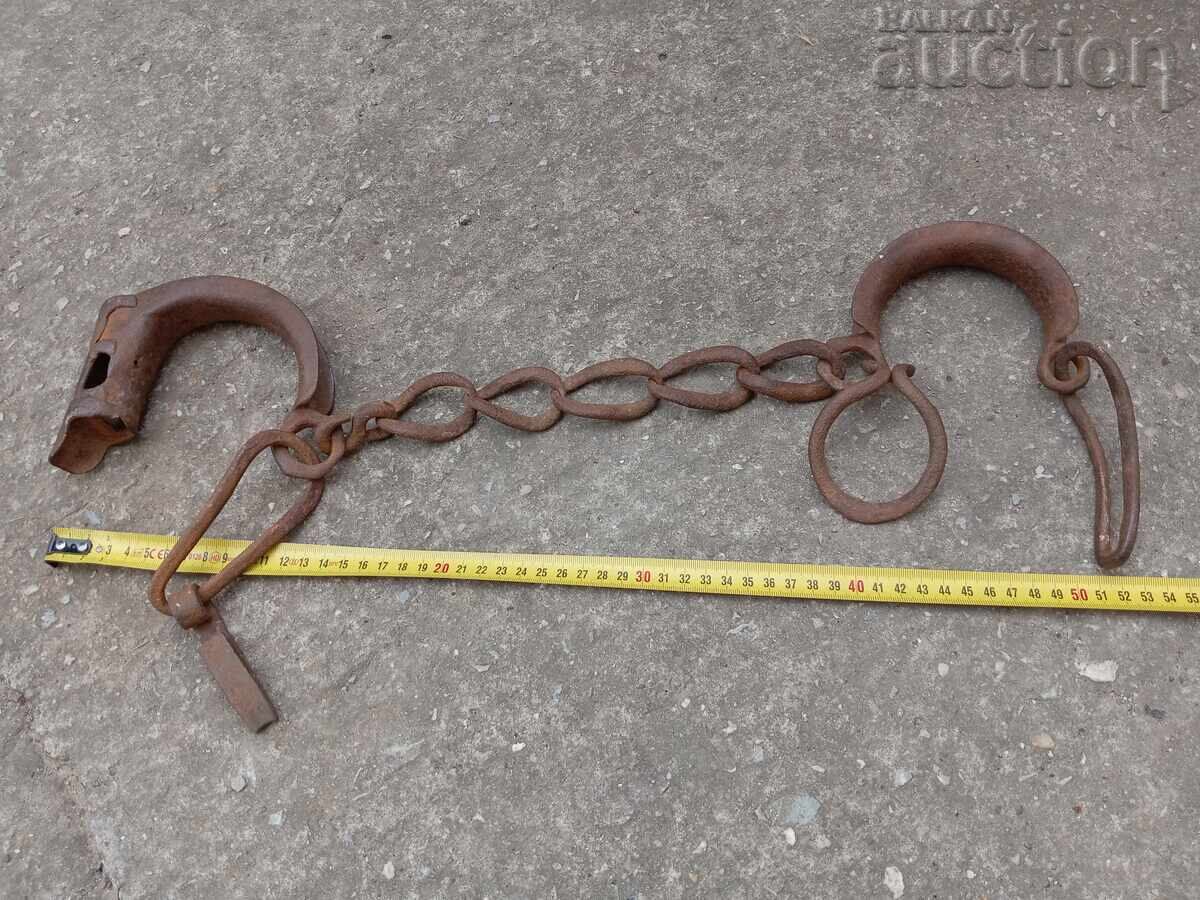 Old hand forged buckles, chains, shackles, shackles with padlock Old hand forged buckles, chains, shackles, shackles with padlock