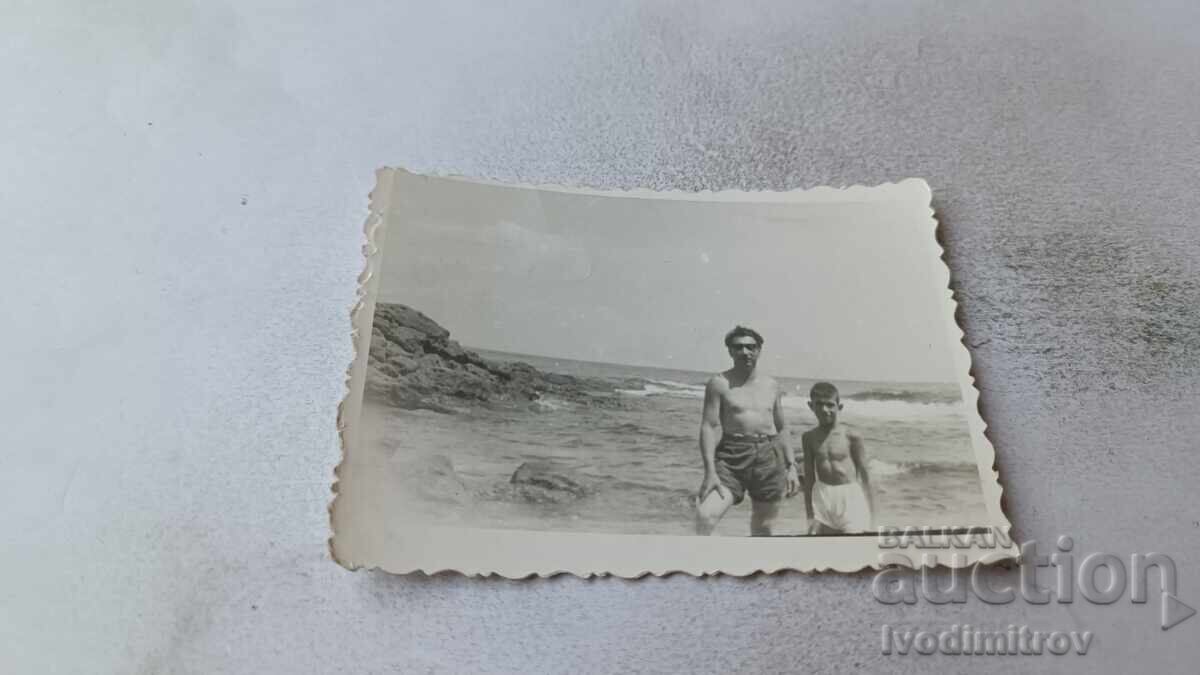 Снимка Мъж и момче на брега на морето Снимка Мъж и момче на брега на морето