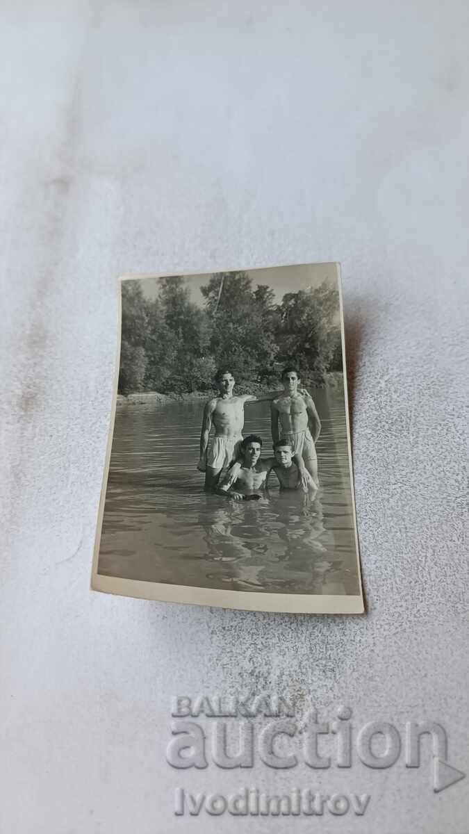 Photo of Four Young Men in the Sea Photo of Four Young Men in the Sea