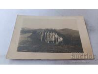 Photo Man women and children along the road