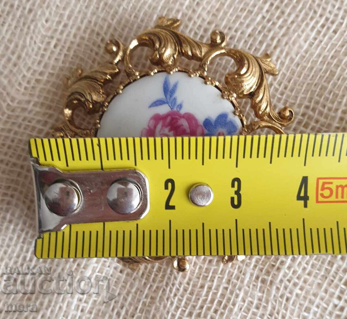 Auction  Porcelain brooch with rhinestones