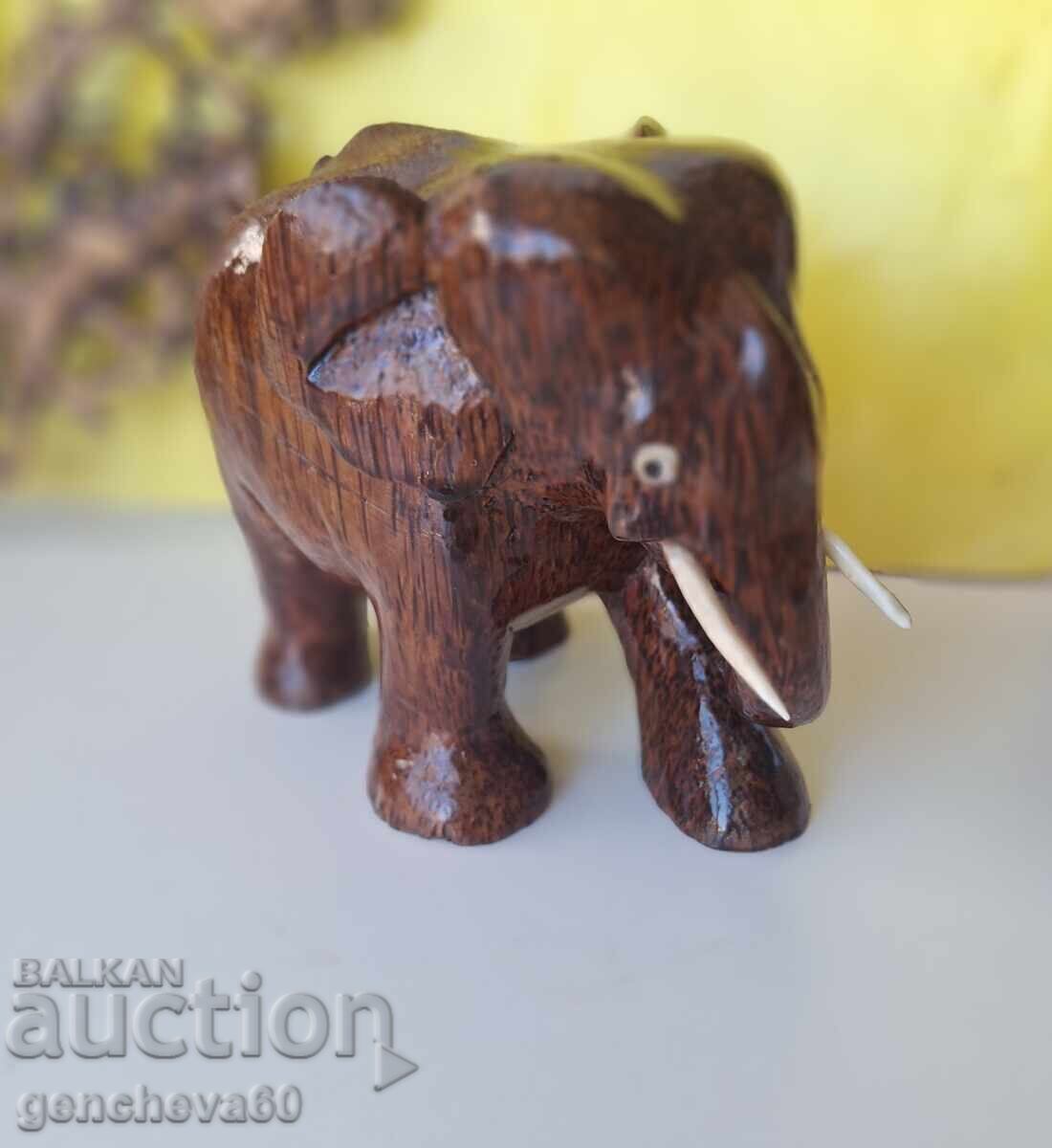 Hand-carved wooden elephant figure with price 12.00 €