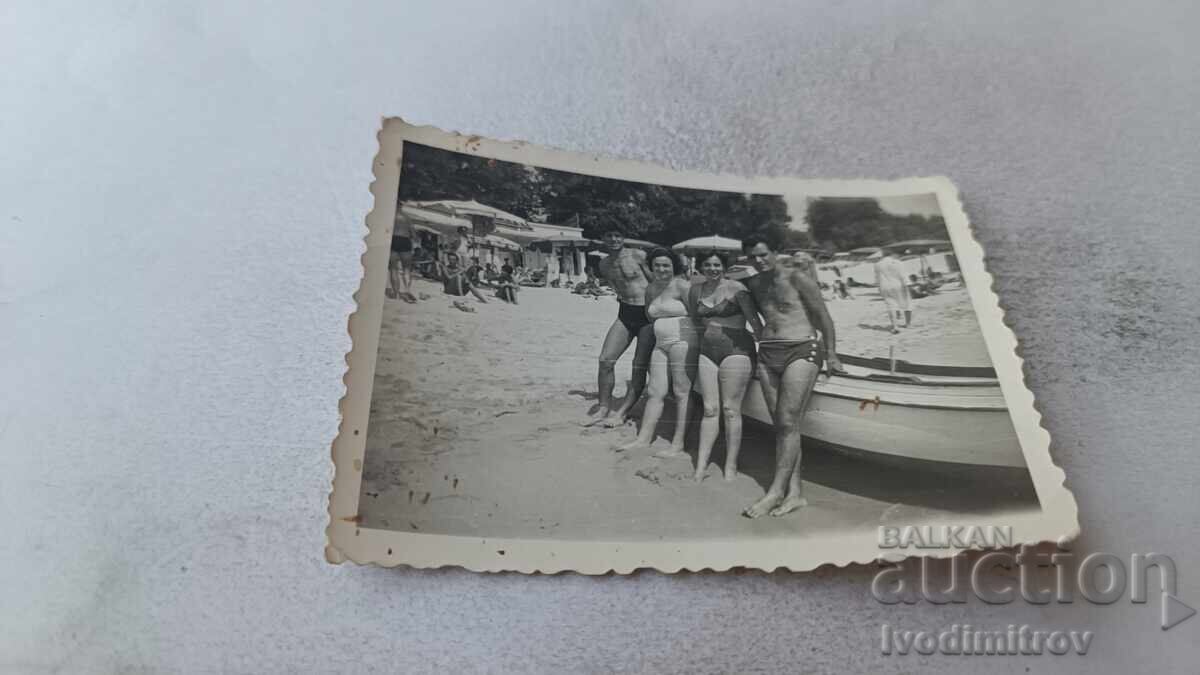 Photo: Men and women near a boat for beach excursions