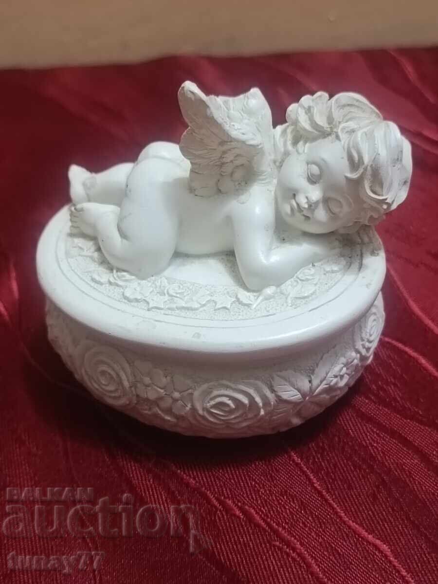 Jewelry seated angel with a small bouquet in raised right hand