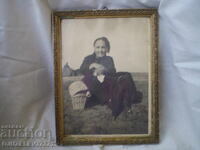 Retro frame with a photo of an elderly woman and a man with a cart