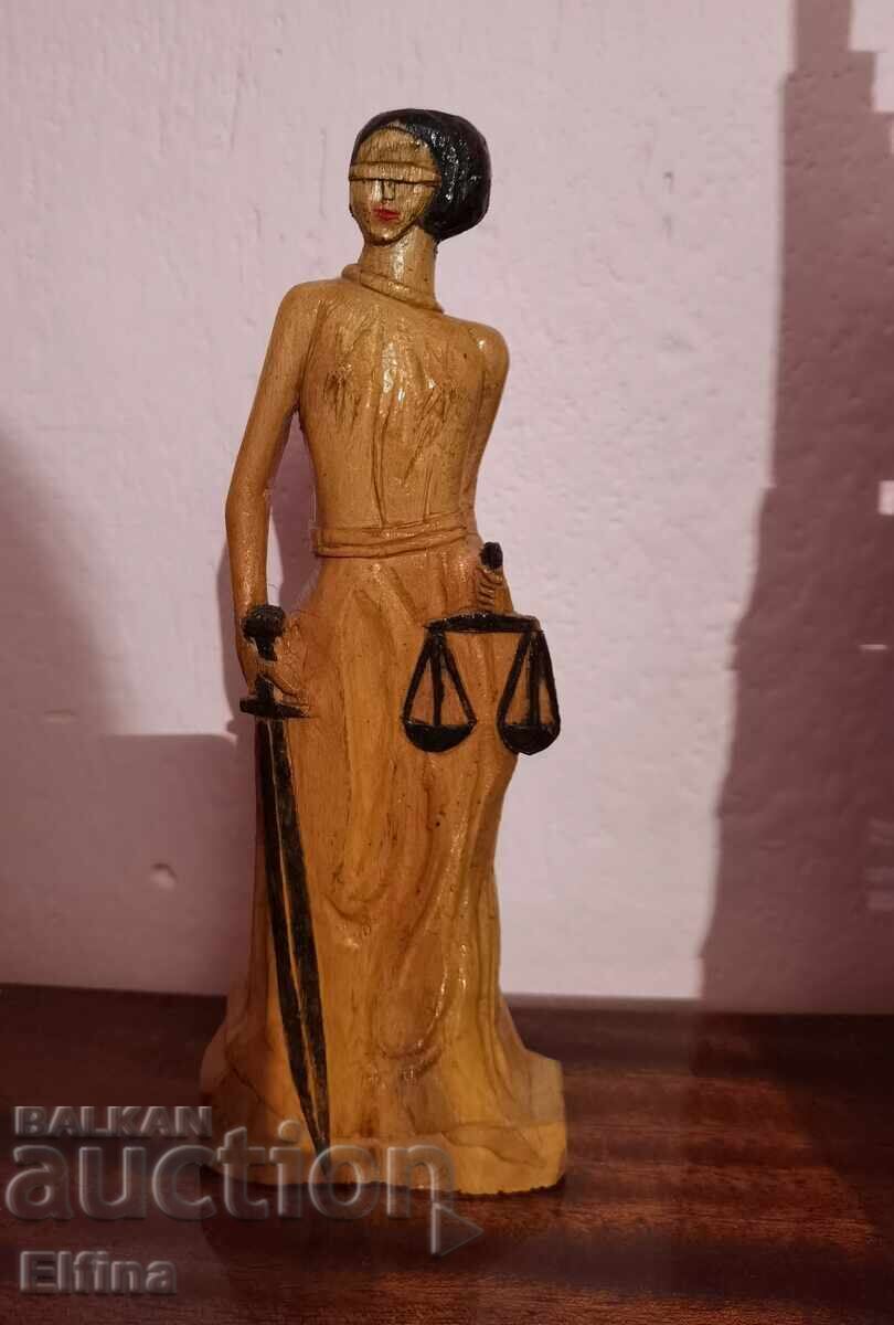 Elegant wooden statuette of the goddess of justice Themis