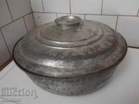 Old copper pot with lid