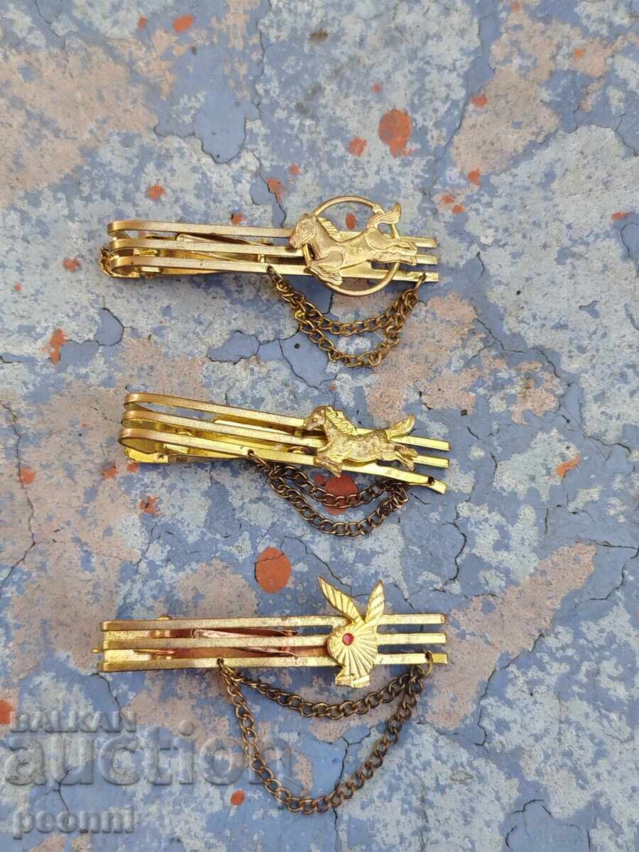 Three gold-plated tie clips