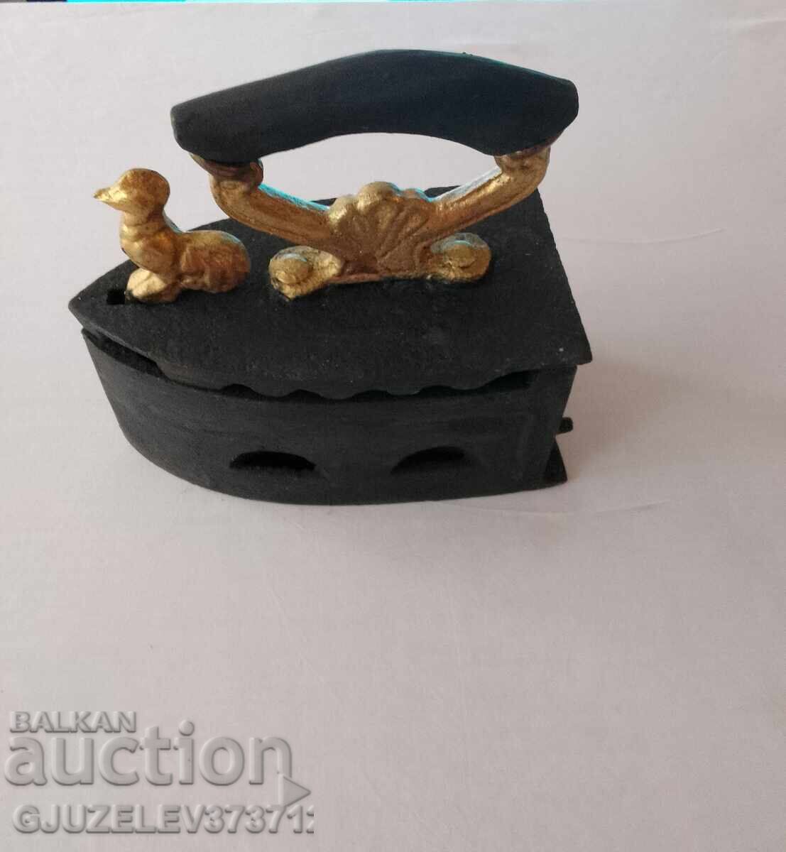 An old cast iron iron on fire