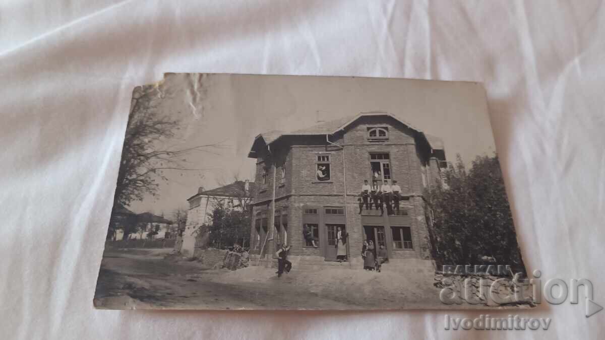Photo of men and women in front of a newly built two-story house