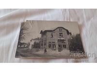 Photo of men and women in front of a newly built two-story house