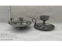 Two candle holders with handles, with markings