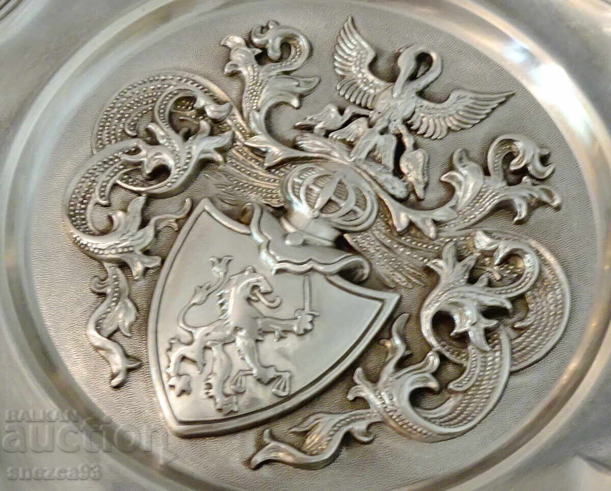Auction  Pewter plate, pewter panel with family symbols, pewter