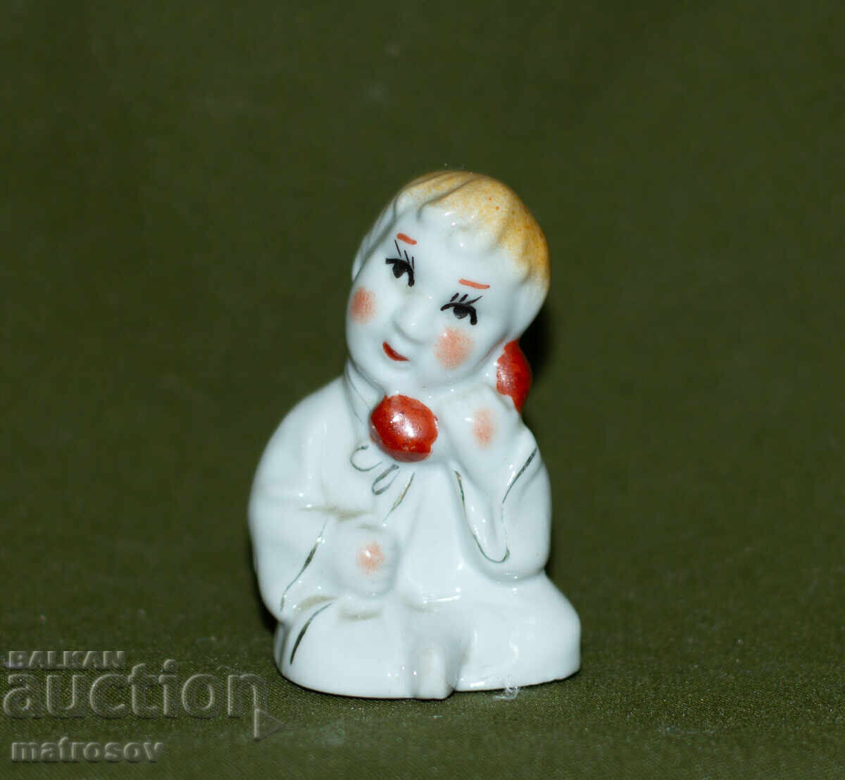 Old decorative porcelain figurine of a child with a telephone with price 50.00 BGN | € 25.56