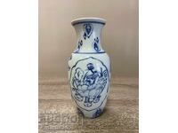 Porcelain vase with blue plant ornament