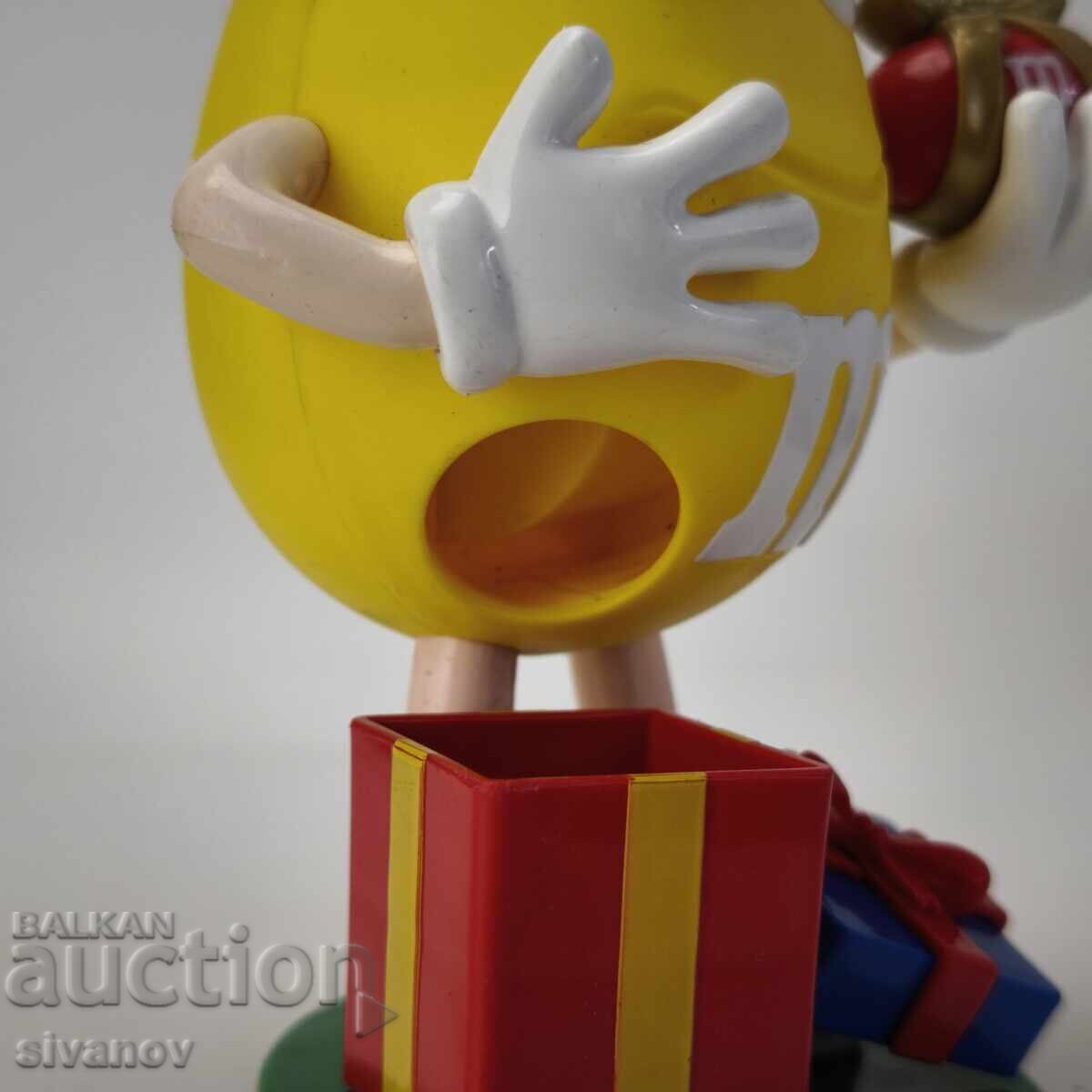 Dozator de bomboane M&M's galben, ediție de Crăciun #6176 cu preț 19.99 BGN | € 10.22 Dozator de bomboane M&M's galben, ediție de Crăciun #6176 cu preț 19.99 BGN | € 10.22