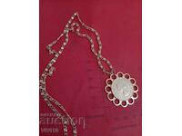 Antique necklace with a coin