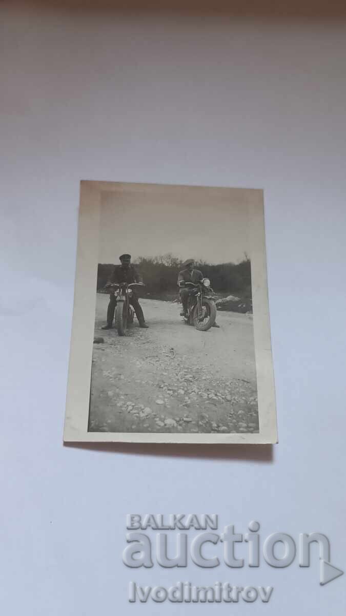 Photo of an Officer and a man with retro motorcycles on the road Photo of an Officer and a man with retro motorcycles on the road