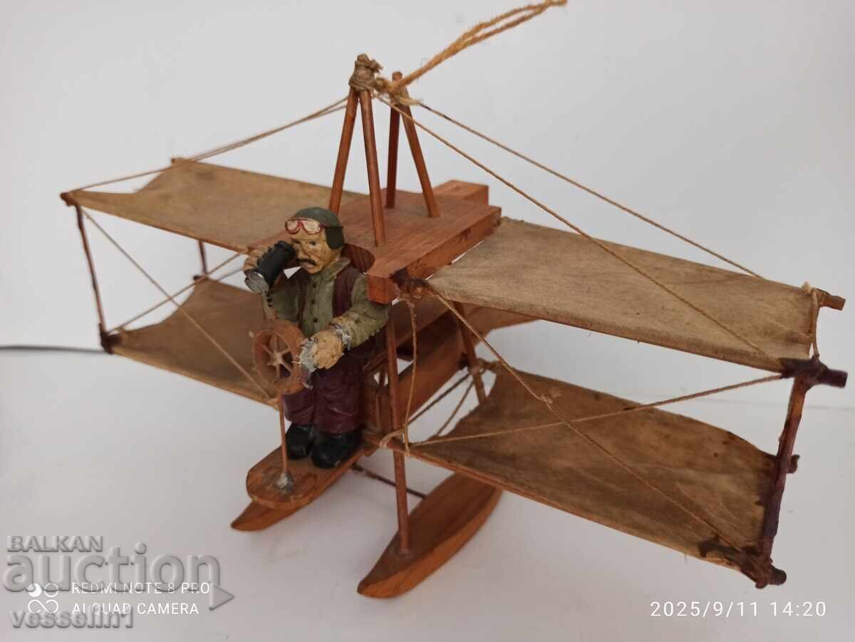 Very old toy airplane with pilot, flying apparatus, wood