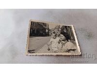 Photo of a Woman and a Little Boy on the Sidewalk