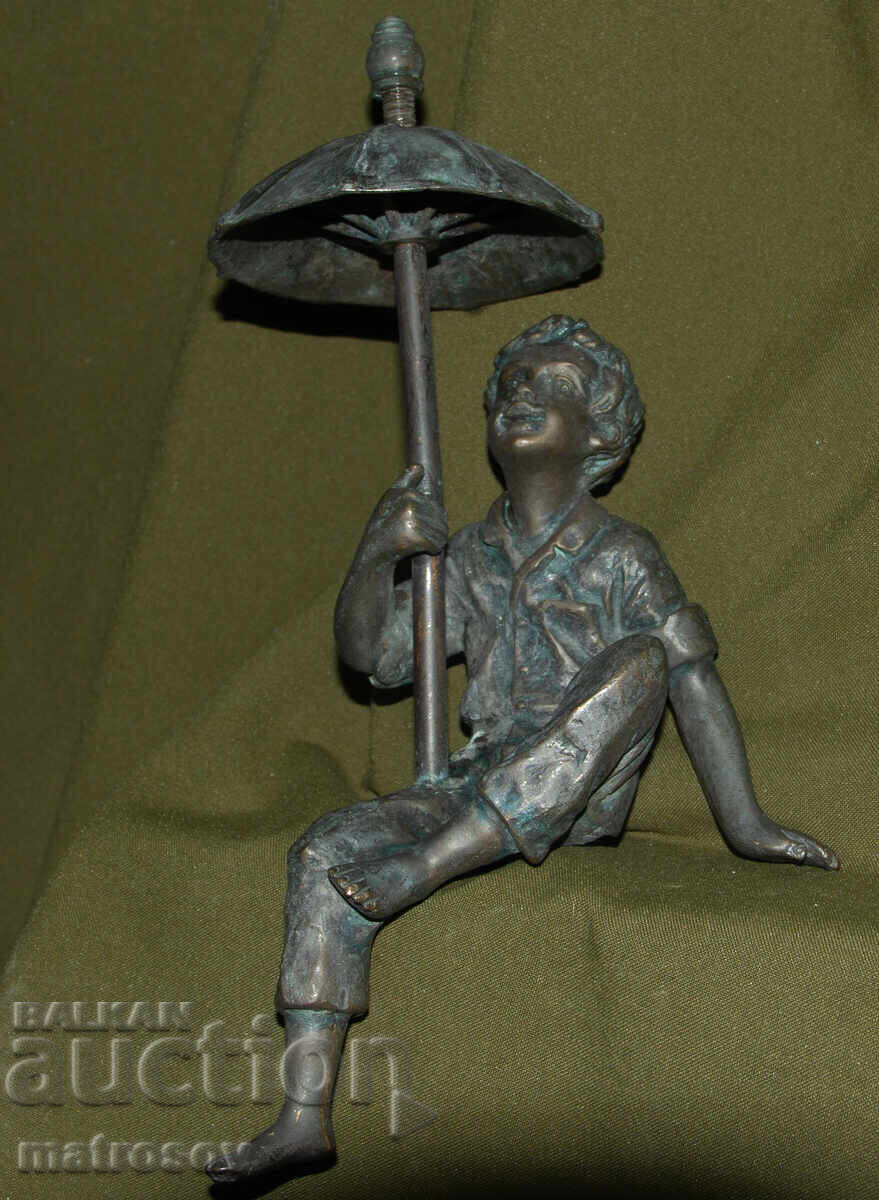 Delivery of Old bronze sculpture of a boy with an umbrella