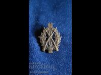 Σήμα, κονκάρδα, μετάλλιο σκοποβολής