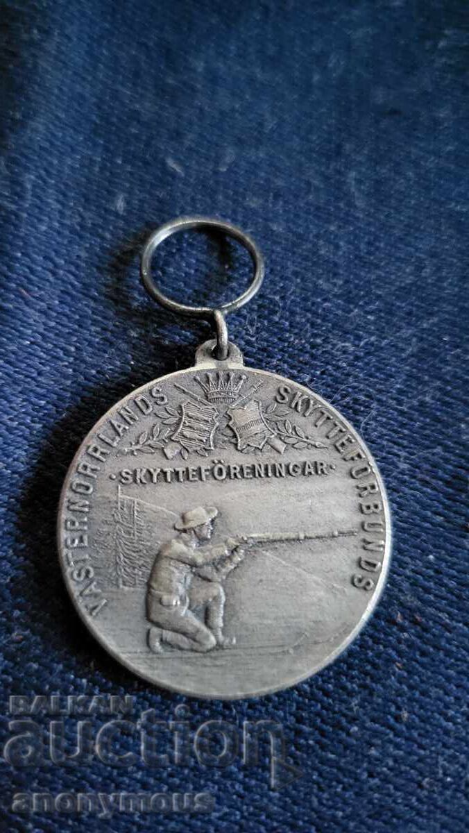 Σήμα, κονκάρδα, μετάλλιο σκοποβολής