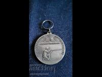 Σήμα, κονκάρδα, μετάλλιο σκοποβολής