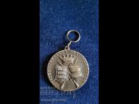 Σήμα, κονκάρδα, μετάλλιο σκοποβολής