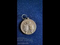 Σήμα, κονκάρδα, μετάλλιο σκοποβολής