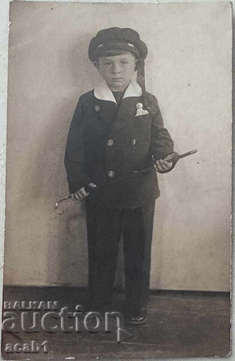 Photograph of a boy in uniform and with a cane Photograph of a boy in uniform and with a cane