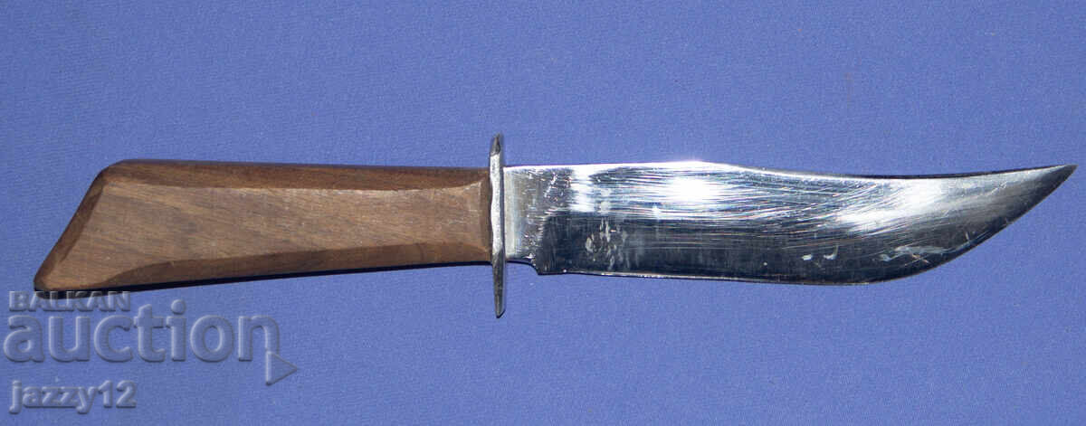 Solid hunting knife with a wooden handle Solid hunting knife with a wooden handle