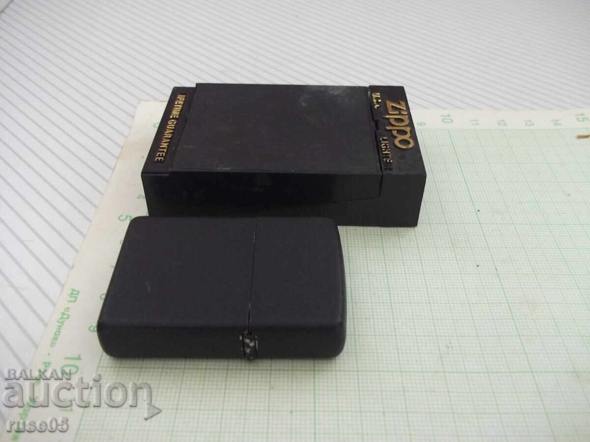 Auction  Zippo petrol lighter, black, with working flint