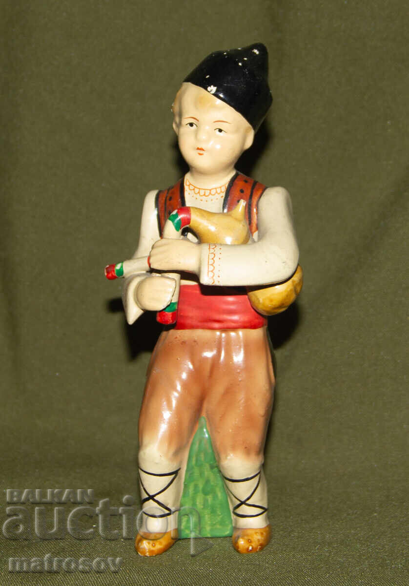 Decorative porcelain figurine, bagpiper