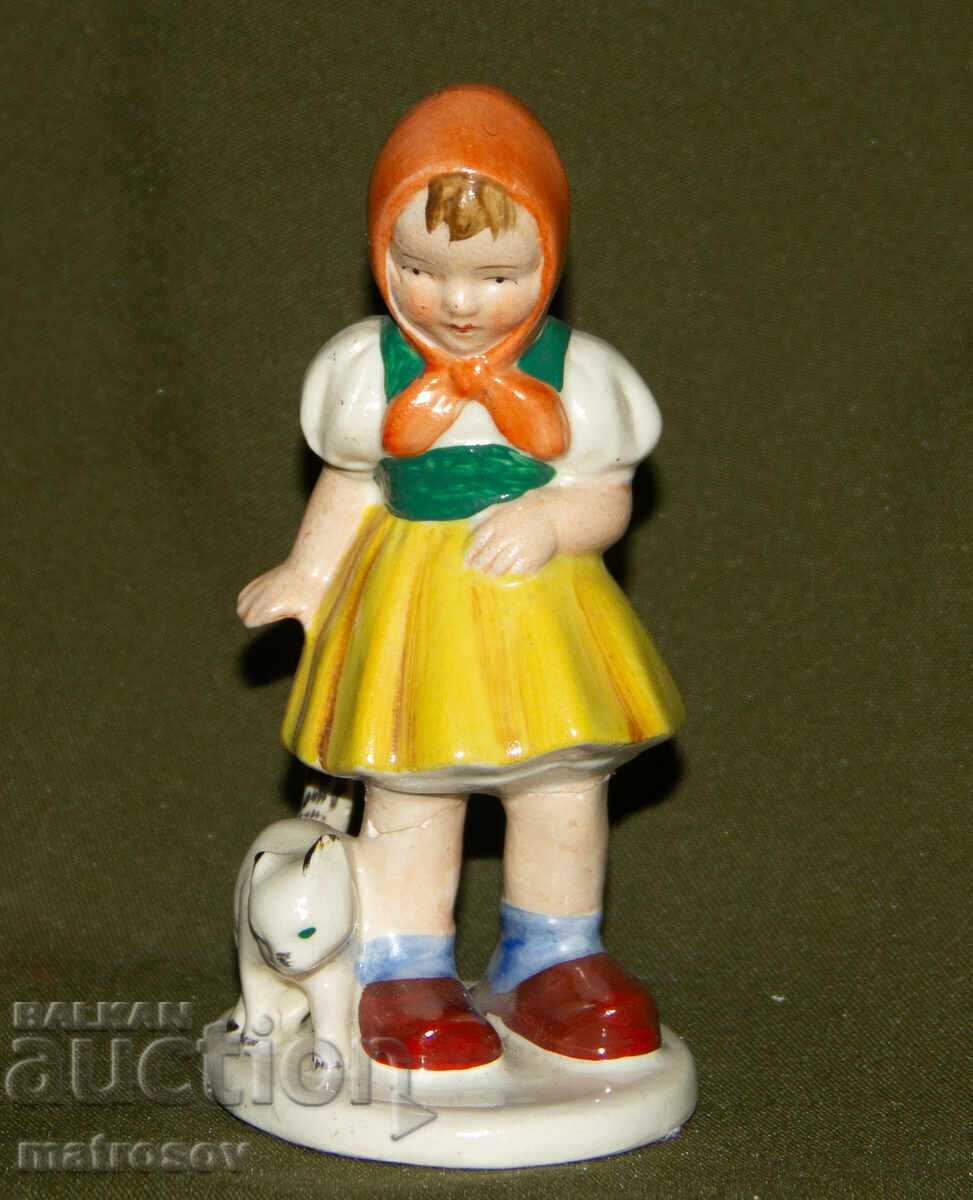 Old porcelain figurine of a girl with a cat