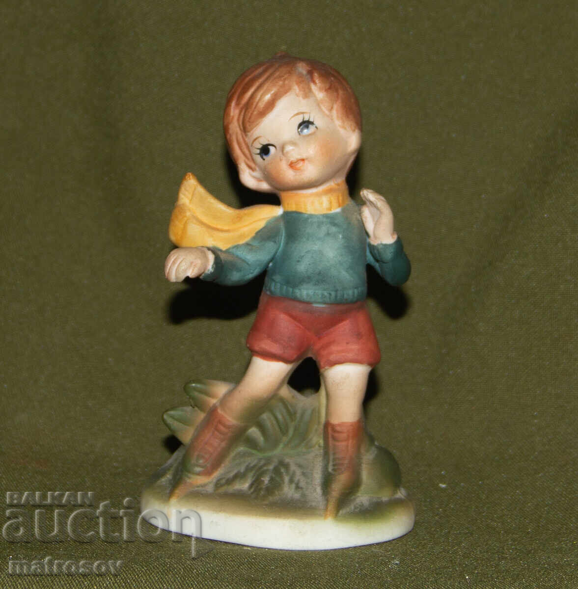 Old porcelain figurine, child on skates