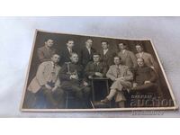 Photo of an Officer and a Group of Men