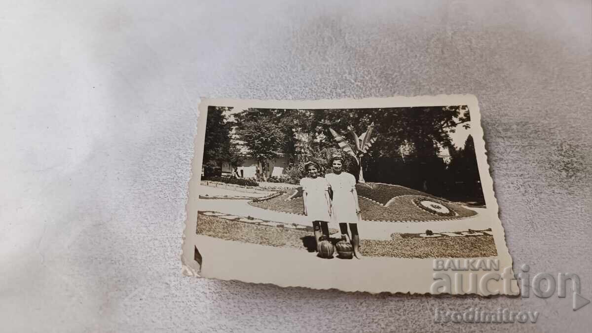 Φωτογραφία Δύο νεαρών κοριτσιών με δύο στάμνες νερού στο πάρκο