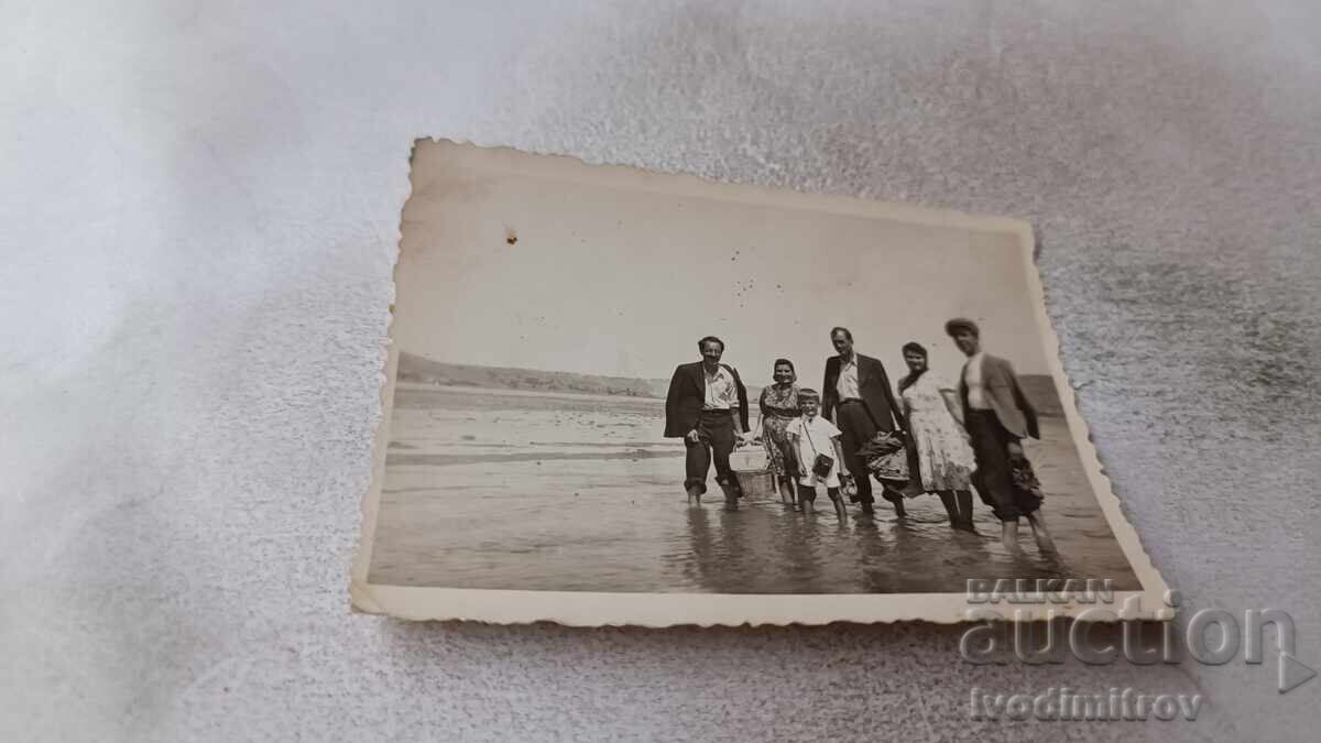 Photo Men women and boy in the river