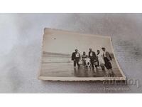 Photo Men women and boy in the river