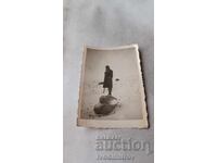 Photo of a woman climbing on a rock in winter