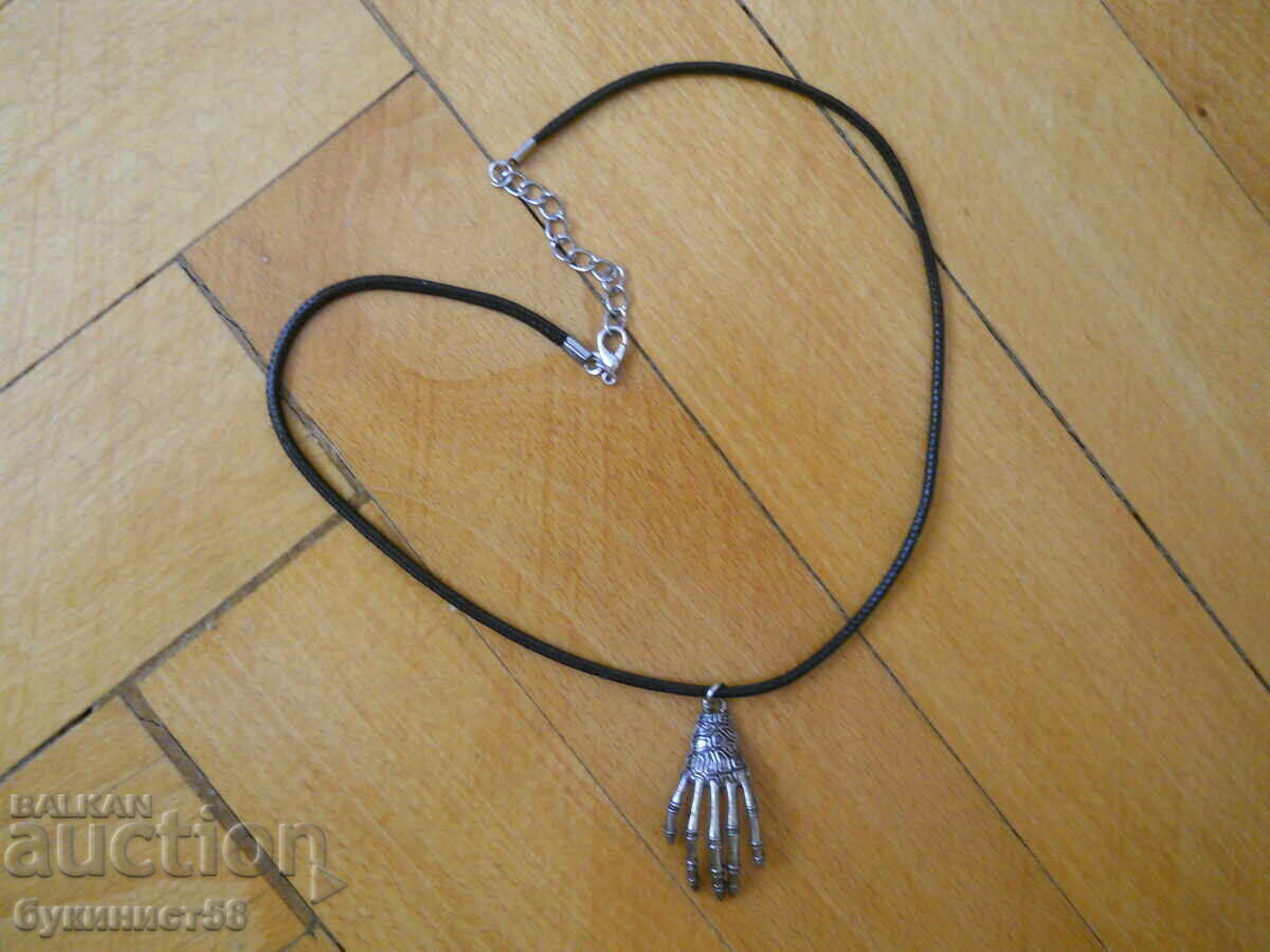 Rock-style pendant "Skeletal hand" on a leather strap